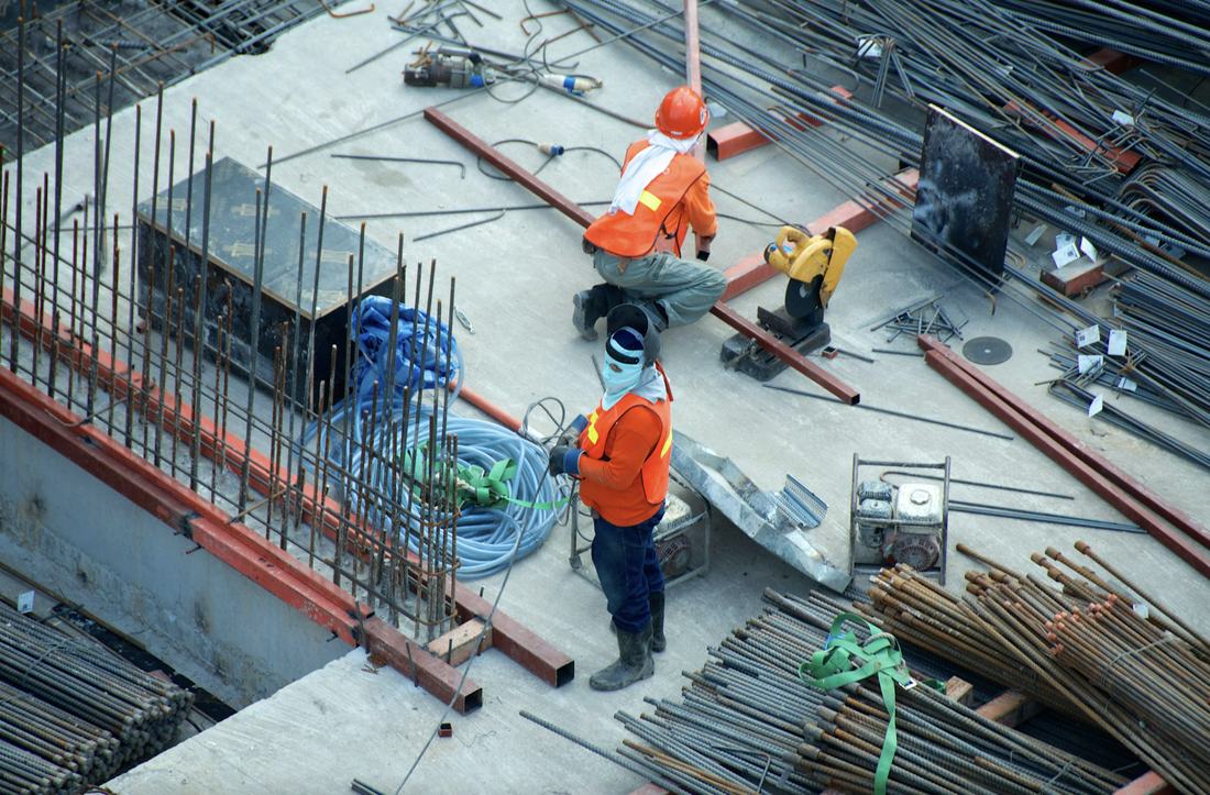 Construction workers on site with reinforcement steel